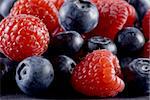 Closeup of fresh blueberries and raspberries mixed toghether