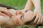 Young girl on the grass. casual style. soft make-up.