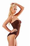 stunning blond young woman in brown swimsuit looking in camera on white