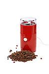 Nice modern red electric coffee grinder near lot of beans