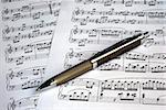 A pen on the top of music sheets