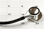 A stethoscope on the calendar concepts of medical appointment