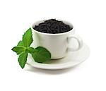 Cup of black tea with mint leaf on white background