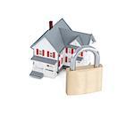 Concept images of a miniature grey house with a padlock against a white background