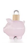 Side view of pink piggy bank and padlock against a white background.