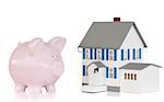 House and pink piggy bank against a white background