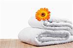 White towels under a sunflower against a white background