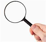 Hand holding a magnifying glass against a white background