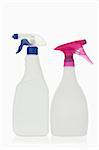 Pink and blue spray bottles against a white background