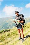 Man with the knapsack holds the map