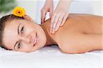 Close up of a beautiful woman having a shoulder massage in a spa