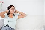 Lovely brunette listening to music in her living room
