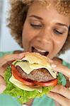 Mid Adult Woman Eating A Burger