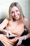 Girl holding a remote control and smiling