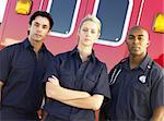 Portrait of paramedics standing in front of an ambulance