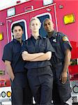 Portrait of paramedics standing in front of an ambulance