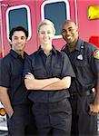 Portrait of paramedics standing in front of an ambulance