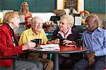 Senior adults having morning tea together