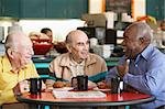 Senior men drinking tea together