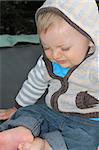 Baby boy playing outside in the garden wearing jersey