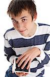 A young smiling boy eating fresh healthy blueberries.  Blueberries are a super food high in antioxidants.