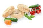 three sesame bagel with vegetables on white background