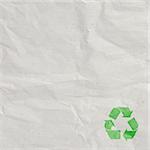 A recycled paper background with green sign