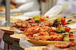 Thai cuisine barbecue chicken and pork skewers at Chatuchak weekend market in Bangkok, Thailand