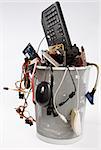 electronic scrap in trash can. keyboard, power supply, mouse, cables, fan, pci-cards