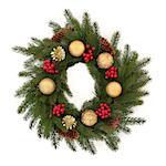 Christmas wreath of pine fir with red holly berry clusters, pine cones and golden bauble decorations isolated over white background.