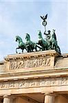 Detail of Brandenburg Gate and the Quadriga bronze statue. In german it is called Brandenburger Tor and it's one of the few monuments that survived in the defeated capitol town of Berlin after second world war. King Frederick William II of Prussia commissioned the Gate and Carl Gotthard Langhans built it from 1788 to 1791.