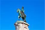 Statue of King Joao I at Figueiroa Square, and St. Jorge castle in Lisbon, Portugal