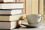 Composition with books and cup of coffee on the table