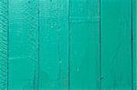 Fragment of old wooden fence painted in bright aquamarine