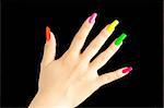 Colorful manicure on real nails over black background