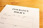 insurance policy form on desk in office showing risk concept