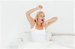 Woman waking up in her bedroom