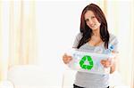 Good looking woman holding recycling bin