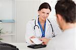 A female doctor is giving a patient a prescription