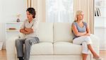 Couple angry at each other sitting on a sofa