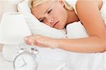 Woman awaken by an alarmclock in her bedroom