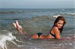 beautiful young woman bathing in the sea