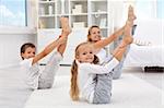 Healthy morning stretching - woman with kids doing gymnastic exercise at home