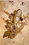 Antique brass sextant and map