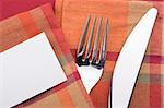 Knife and fork on a red napkin - tableware.