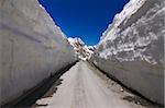 Barlachala pass in Leh Manali Highway, roads through ice walls with snow peak of himalaya in background