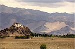 A small monastery near medieval city of Leh in top of a small hill with mountains in background