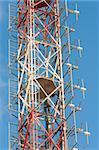 Telecom mast with multiple uses against blue sky background