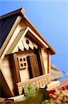 Little wooden house model under blue sky