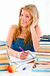 Smiling young girl sitting at table with lots of books